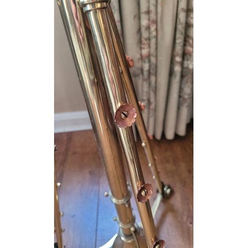 17 - A VERY GOOD QUALITY WROUGHT BRASS STANDARD LAMP, with scrolling supports dotted with copper coloured... 