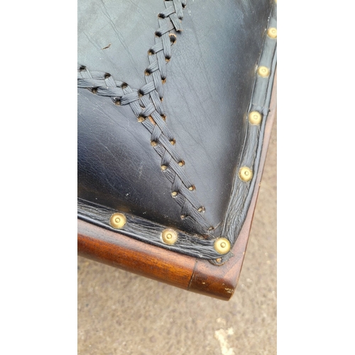 177 - A GOOD QUALITY REGENCY STYLE ‘X’ FRAME LEATHER TOPPED FOOTSTOOL, with stud upholstered leather top, ... 