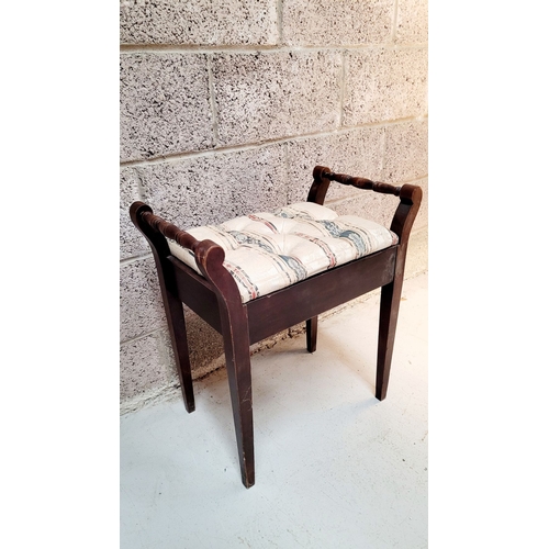 189 - AN ANTIQUE PIANO STOOL, with padded button topped lift away seat, on each side turned elbow rest han... 