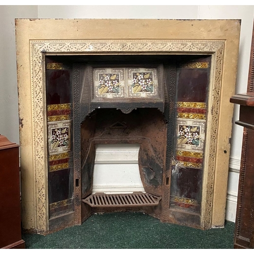 202 - A DECORATIVE ANTIQUE CAST IRON FIRE SURROUND/FIREPLACE INSERT, with original hand glazed coloured fl... 