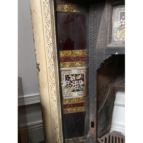 202 - A DECORATIVE ANTIQUE CAST IRON FIRE SURROUND/FIREPLACE INSERT, with original hand glazed coloured fl... 