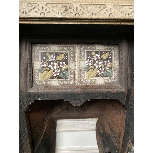 202 - A DECORATIVE ANTIQUE CAST IRON FIRE SURROUND/FIREPLACE INSERT, with original hand glazed coloured fl... 