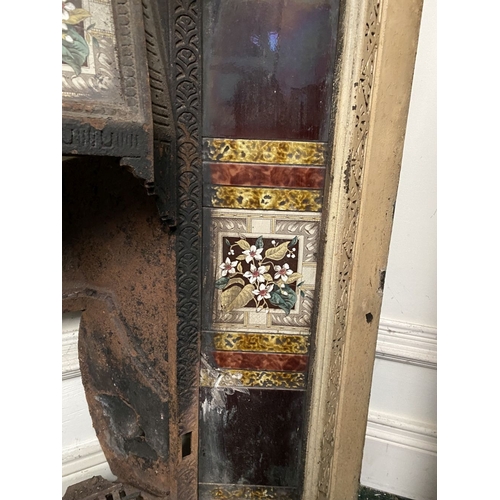 202 - A DECORATIVE ANTIQUE CAST IRON FIRE SURROUND/FIREPLACE INSERT, with original hand glazed coloured fl... 