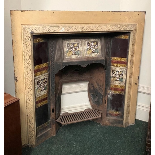 202 - A DECORATIVE ANTIQUE CAST IRON FIRE SURROUND/FIREPLACE INSERT, with original hand glazed coloured fl... 