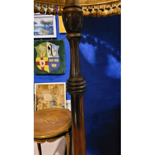 209 - A MAHOGANY STANDARD LAMP WITH SHADE, the tall floor standing lamp has turned column support with a w... 