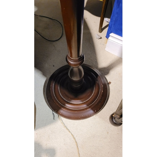 209 - A MAHOGANY STANDARD LAMP WITH SHADE, the tall floor standing lamp has turned column support with a w... 