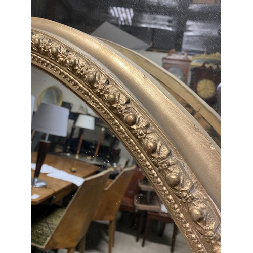 220 - A BEAUTIFUL LARGE DECORATIVE OVAL OVERMANTLE/HALL MIRROR, with intricately carved frame featuring do... 