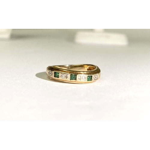 227 - A DAINTY 9CT YELLOW GOLD EMERALD AND DIAMOND BAND RING, with three princess cut emeralds, each separ... 