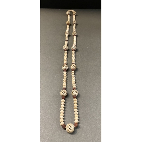 232 - TWO GRADUATED CARVED BONE NECKLACES ALONG WITH TWO HIGHLY CARVED BONE NECKLACES, the graduated pair ... 