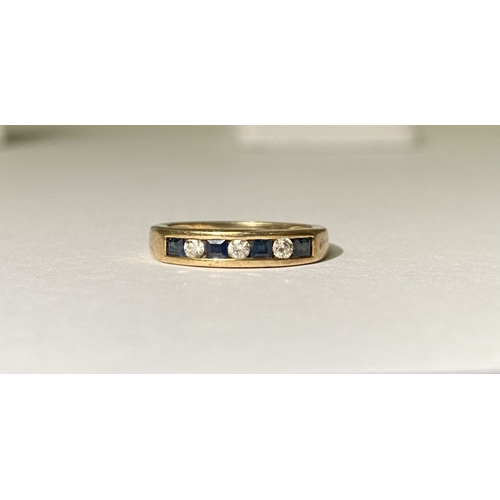 233 - A PRETTY 9CT YELLOW GOLD SAPPHIRE AND DIAMOND BAND RING, with four princess cut sapphires separated ... 