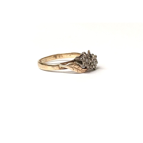 235 - A UNIQUE TWO STONE DIAMOND RING, with two round cut diamonds in illusion floral setting, the split s... 