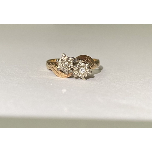 235 - A UNIQUE TWO STONE DIAMOND RING, with two round cut diamonds in illusion floral setting, the split s... 