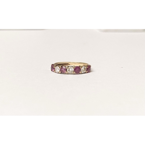 236 - A BEAUTIFUL HALF ETERNITY GEMSET BAND RING, with four round cut red gemstones separated by three rou... 