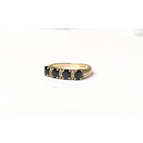 238 - A 9CT YELLOW GOLD SAPPHIRE AND DIAMOND BAND RING, with four oval cut sapphires in four prong claw se... 