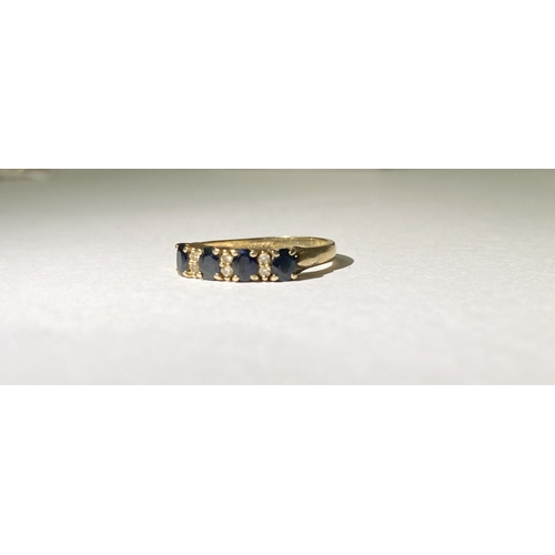 238 - A 9CT YELLOW GOLD SAPPHIRE AND DIAMOND BAND RING, with four oval cut sapphires in four prong claw se... 