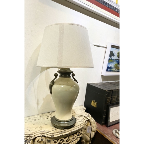 240 - A GOOD VINTAGE URN TABLE LAMP, with scroll handles to sides, body of bulbous form and circular platf... 