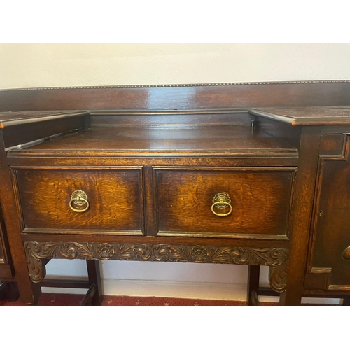 253 - A GOOD BREAKFRONT SIDEBOARD, with gallery to back, one drawer to centre flanked by two panelled door... 