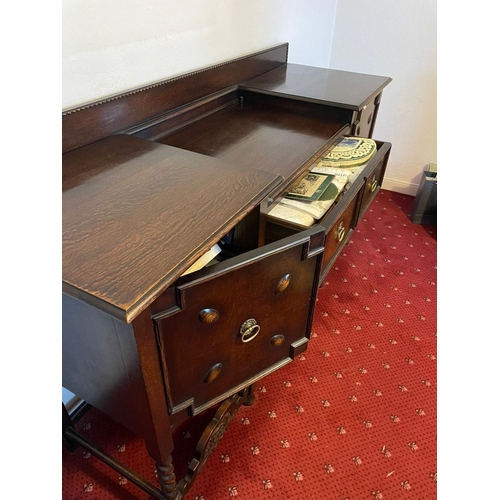 253 - A GOOD BREAKFRONT SIDEBOARD, with gallery to back, one drawer to centre flanked by two panelled door... 