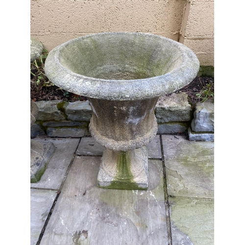 254 - A LARGE PAIR OF STONE GARDEN CAMPANA URNS, on square platform bases. Dimensions: 59cm diameter x 75c... 