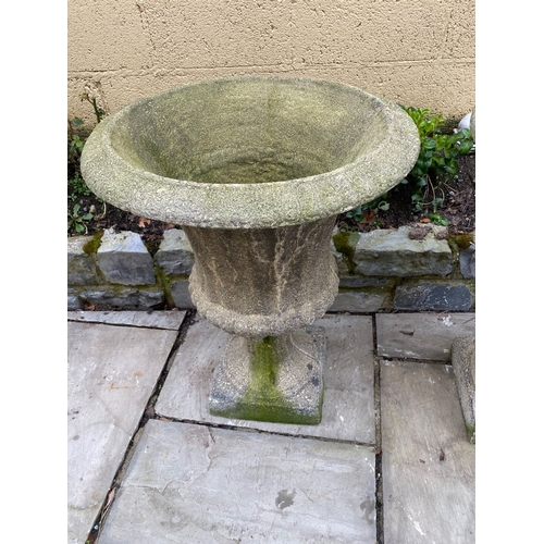 254 - A LARGE PAIR OF STONE GARDEN CAMPANA URNS, on square platform bases. Dimensions: 59cm diameter x 75c... 