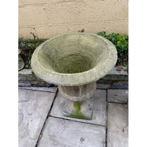 254 - A LARGE PAIR OF STONE GARDEN CAMPANA URNS, on square platform bases. Dimensions: 59cm diameter x 75c... 