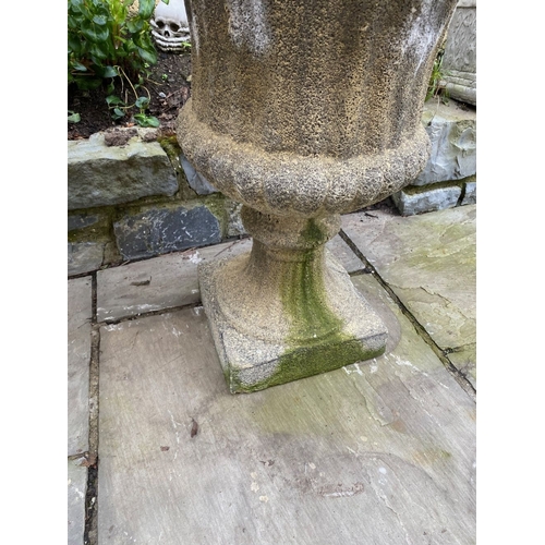 254 - A LARGE PAIR OF STONE GARDEN CAMPANA URNS, on square platform bases. Dimensions: 59cm diameter x 75c... 