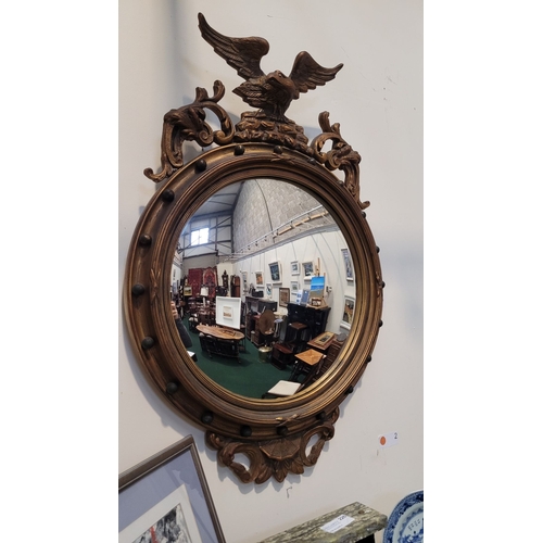 265 - A LARGE CONVEX WALL MIRROR WITH EAGLE PEDIMENT MOUNT, the frame with 20 balls to the centre, the mou... 