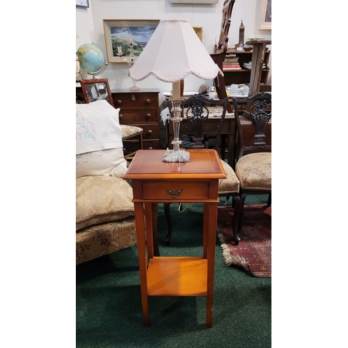 268 - A TALL SINGLE DRAWER CABINET / LAMP TABLE, raised on square legs united by a lower shelf. The single... 