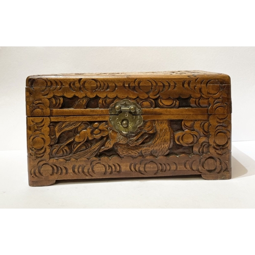 293 - A DECORATIVE CHINESE CARVED CAMHOR WOOD BOX, heavily carved throughout with decorative engraved bras... 