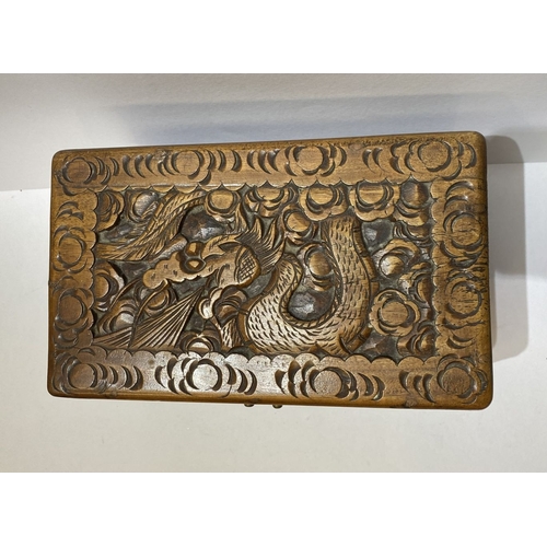 293 - A DECORATIVE CHINESE CARVED CAMHOR WOOD BOX, heavily carved throughout with decorative engraved bras... 