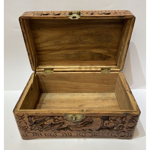 293 - A DECORATIVE CHINESE CARVED CAMHOR WOOD BOX, heavily carved throughout with decorative engraved bras... 