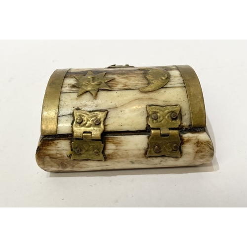 296 - AN ANTIQUE CARVED BONE TRINKET BOX, with brass bindings, decorative brass hinges and clasp to front,... 