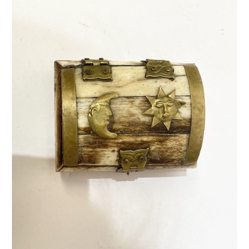 296 - AN ANTIQUE CARVED BONE TRINKET BOX, with brass bindings, decorative brass hinges and clasp to front,... 