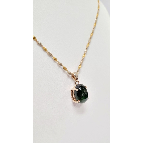 30 - A PRETTY 14CT YELLOW GOLD GREEN SAPPHIRE & DIAMOND PENDANT, the oval shaped cabochon cut natural gre... 