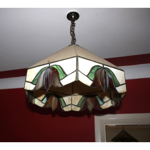 311 - A VINTAGE TIFFANY STYLE STAINED GLASS HANGING LAMPSHADE, the shade having six panels to top and base... 