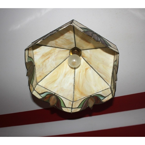 311 - A VINTAGE TIFFANY STYLE STAINED GLASS HANGING LAMPSHADE, the shade having six panels to top and base... 