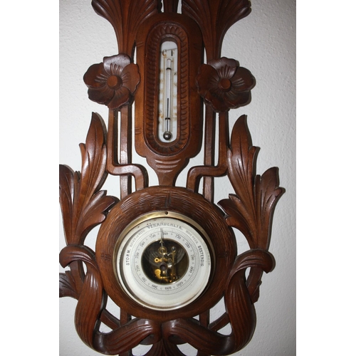 315 - A VINTAGE CARVED DUTCH VERANDERLIJK BAROMETER, with thermometer to top surrounded by intricate flora... 