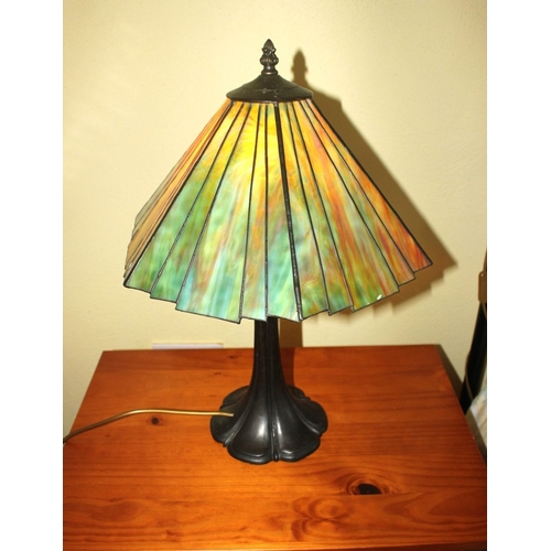 324 - A BEAUTIFUL STAINED GLASS TABLE LAMP, the shade having tapered panels of coloured glass, with finial... 