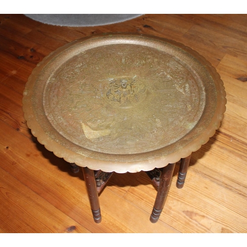 326 - AN ANGLO/INDIAN FOLDING SIDE TABLE, decorative circular brass engraved top with raised scalloped bor... 