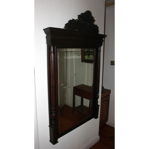 327 - A HIGHLY CARVED BEVELLED GLASS WALL MIRROR, rectangular bevelled mirror in carved frame with crest t... 