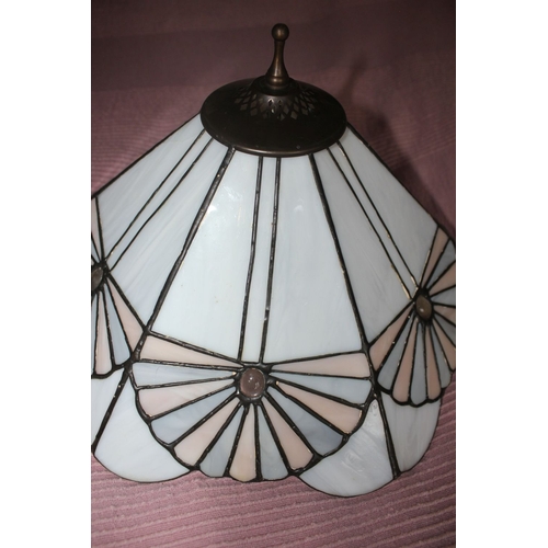 335 - A HEXAGONAL STAINED GLASS HANGING LAMPSHADE, with finial to top, the shade having six main panels sp... 