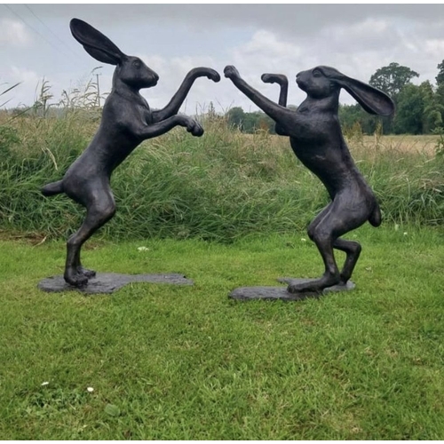 357 - A LARGE GARDEN ORNAMENT IN THE FORM OF TWO BOXING HARES, 3ft all approximately.