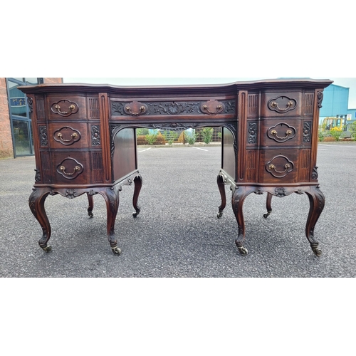 360 - AN EARLY 20TH CENTURY 7 DRAWER LEATHER TOPPED DESK, the top serpentine in shape with inset tooled le... 