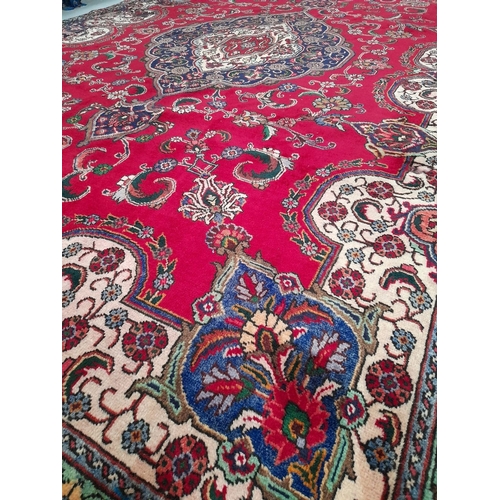 363 - A VIBRANT PERSIAN TABRIZ RUG, hand-knotted, featuring traditional Tabriz design with central medalli... 