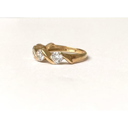 375 - A BEAUTIFUL 14CT GOLD FOUR STONE RING, four round cut clear gemstones in intricate twist setting, sl... 