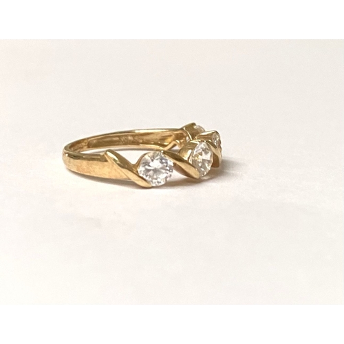 375 - A BEAUTIFUL 14CT GOLD FOUR STONE RING, four round cut clear gemstones in intricate twist setting, sl... 