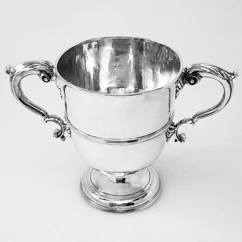 39 - A WONDERFUL IRISH GEORGE II TWO-HANDLED SILVER CUP, the double c scroll handles having acanthus leaf... 