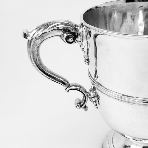 39 - A WONDERFUL IRISH GEORGE II TWO-HANDLED SILVER CUP, the double c scroll handles having acanthus leaf... 