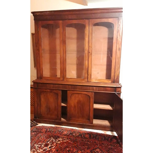 48 - A LARGE THREE BAY VICTORIAN GLAZED BOOKCASE CABINET, superb colour and condition to the wood. The to... 