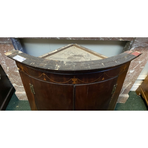 52 - A GEORGIAN BOW FRONTED HANGING CORNER CABINET, with a graduated pediment top, over a row of inlaid u... 